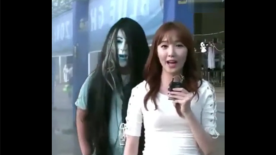 The beautiful girl was broadcasting the news,and then something suddenly appeared behind her.