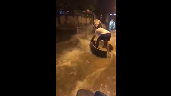 There was a heavy rain in the city of the man, and this guy was driving a speedboat on the road.