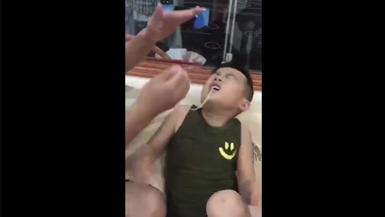 Dad tried to pull his son's teeth out with a thin rope and he failed.