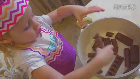 A cute baby is making delicious cake now! Do you want to have a try?