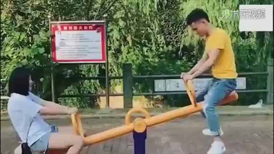 Shocked! Two people play the seesaw! Lady, do you feel embarrassed? The guy can't get   down!