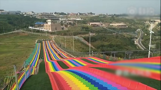 Giant rainbow slide china: Colorful rock speed skating in Xiuyan Mountain Scenic Area.