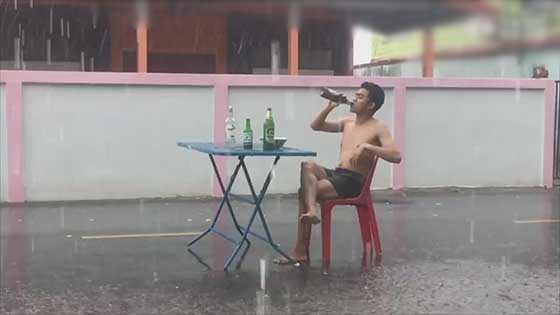 People with stories! Thai men drink and eat red noodles in the rainstorm, invite passers-by to drink.