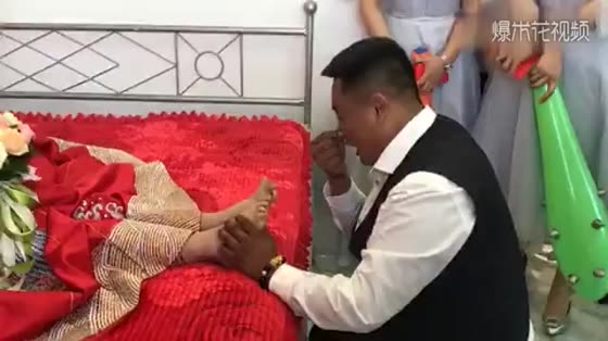 The groom rubs her feet. The bride is very naughty. The groom will make up his mind.