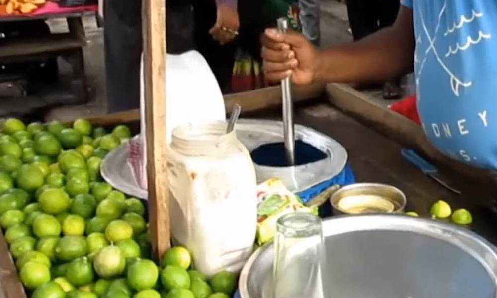 Fresh squeezed lemonade in the streets of India, half a lemon to make a large glass, too much