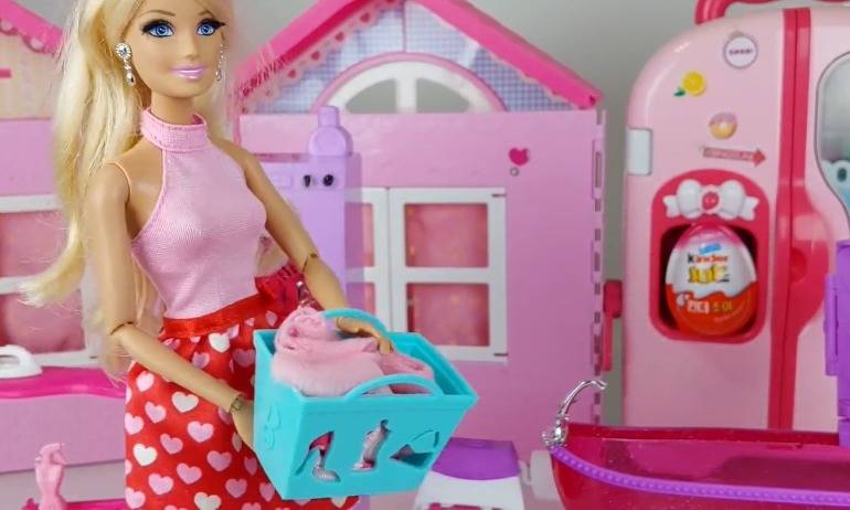 Princess Barbie arranges her dry clothes at home