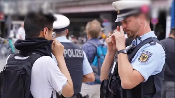 German police asked masked Hong Kong demonstrators to remove masks