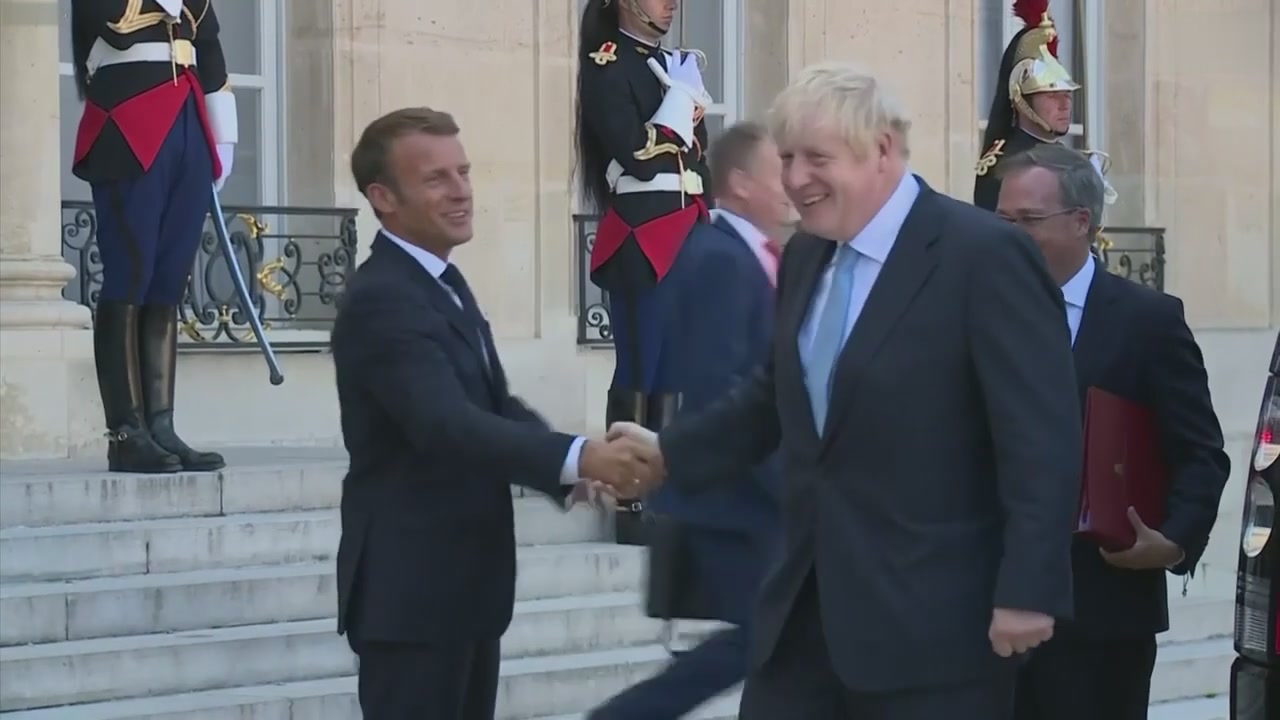 British Prime Minister Boris Johnson shakes hands with French President Emmanuel Macron