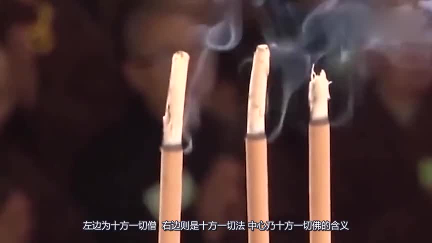 Why are Buddha worshippers holding three incense sticks in their hands?