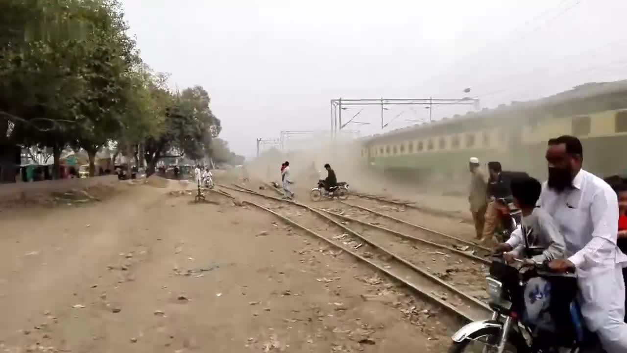 Seeing the train coming at a high speed, the motorcycle is not leaving in a hurry. Are you waiting for the train to make way for you?
