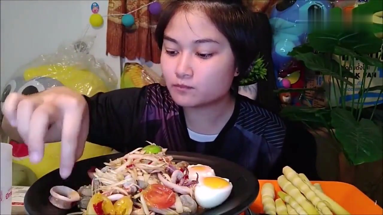 Thai women eat squid salad with boiled eggs. It tastes delicious and tastes delicious.