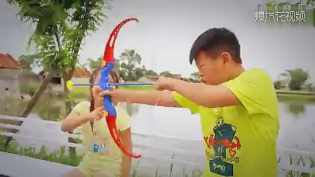 Troubleshooter, a brother and sister play archery game with toy bow, accidentally shoot a honeycomb